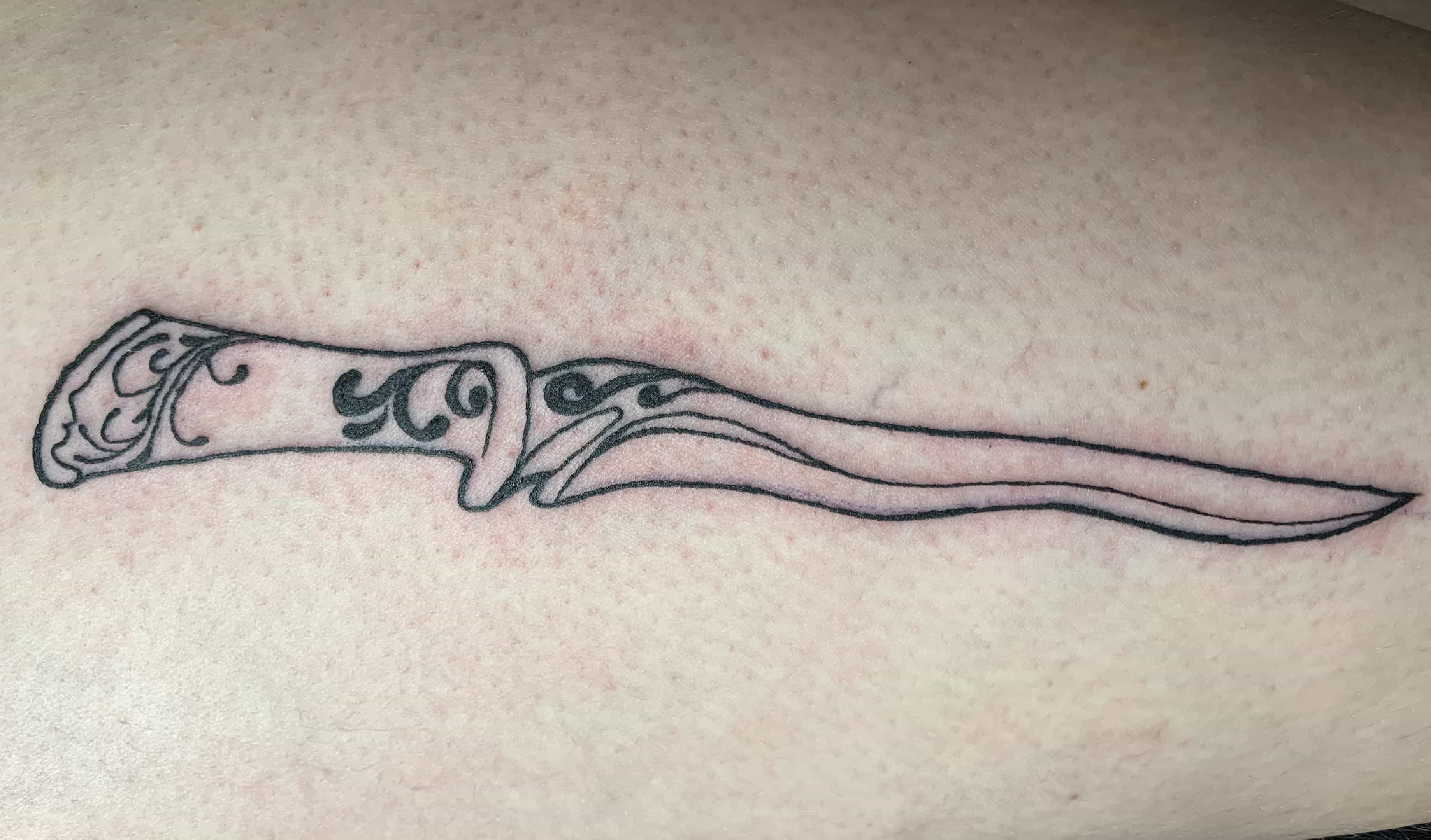 tattoo of a curved dagger